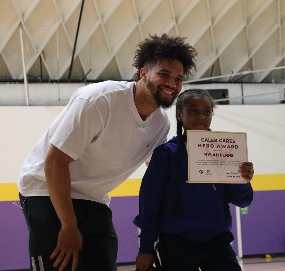 Caleb Williams presenting the Caleb Cares Hero Award to Nylah at the Los Angeles Boys and Girls Club