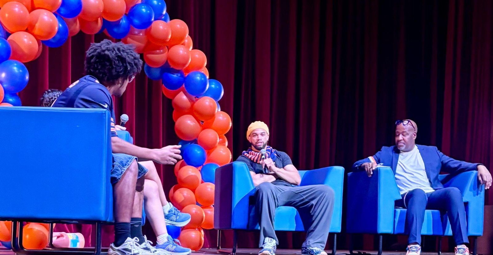 Caleb Williams on stage at a community event